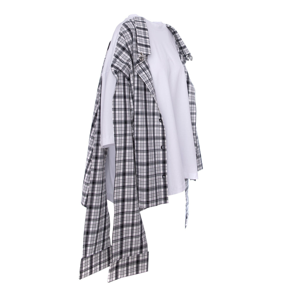 An asymmetrical layered shirt featuring a black and white plaid overshirt draped over a white t-shirt, displayed on a clean white background.