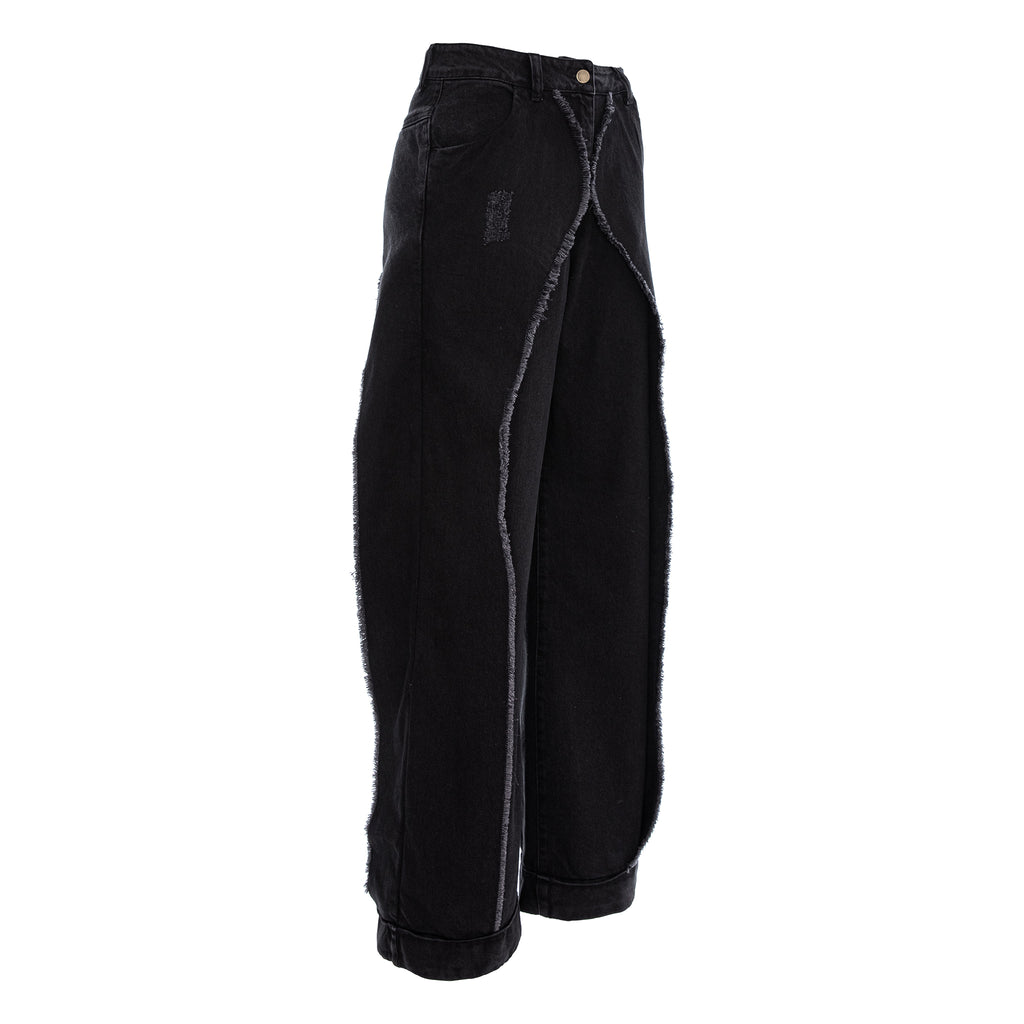 Black wide-leg denim pants with raw, frayed cut edges running down the sides and a small distressed patch on the upper left leg, shown against a plain white background.