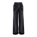 A pair of wide-leg cropped jeans in washed black denim, featuring raw, frayed seam detailing running down the front of each leg and a raw hem, shown against a plain white background.