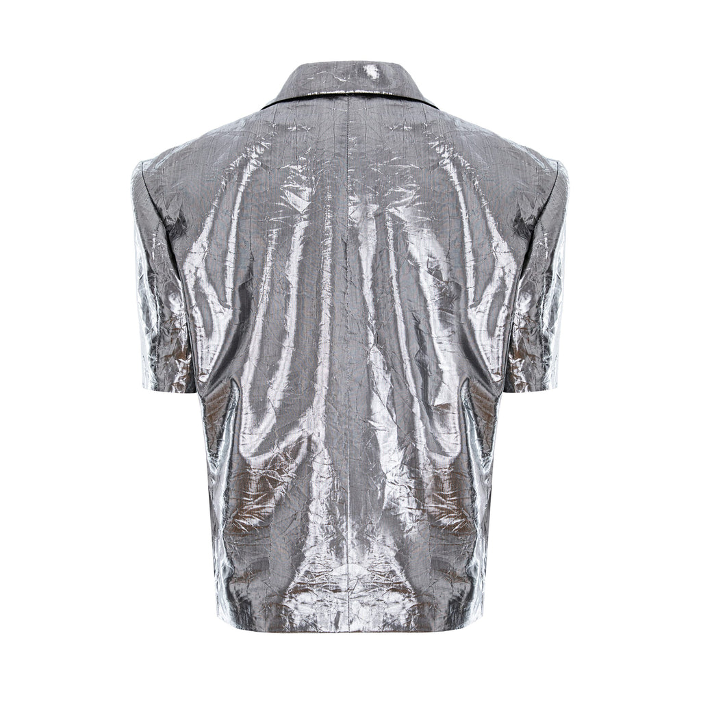 A metallic silver short-sleeve button-up shirt shown from the back, featuring a highly reflective, crinkled texture and a pointed collar, set against a plain white background.