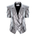 A metallic silver short-sleeve blazer with a crinkled, textured finish, featuring notch lapels, a wrap-style front, and a black inner lining, shown against a plain white background.