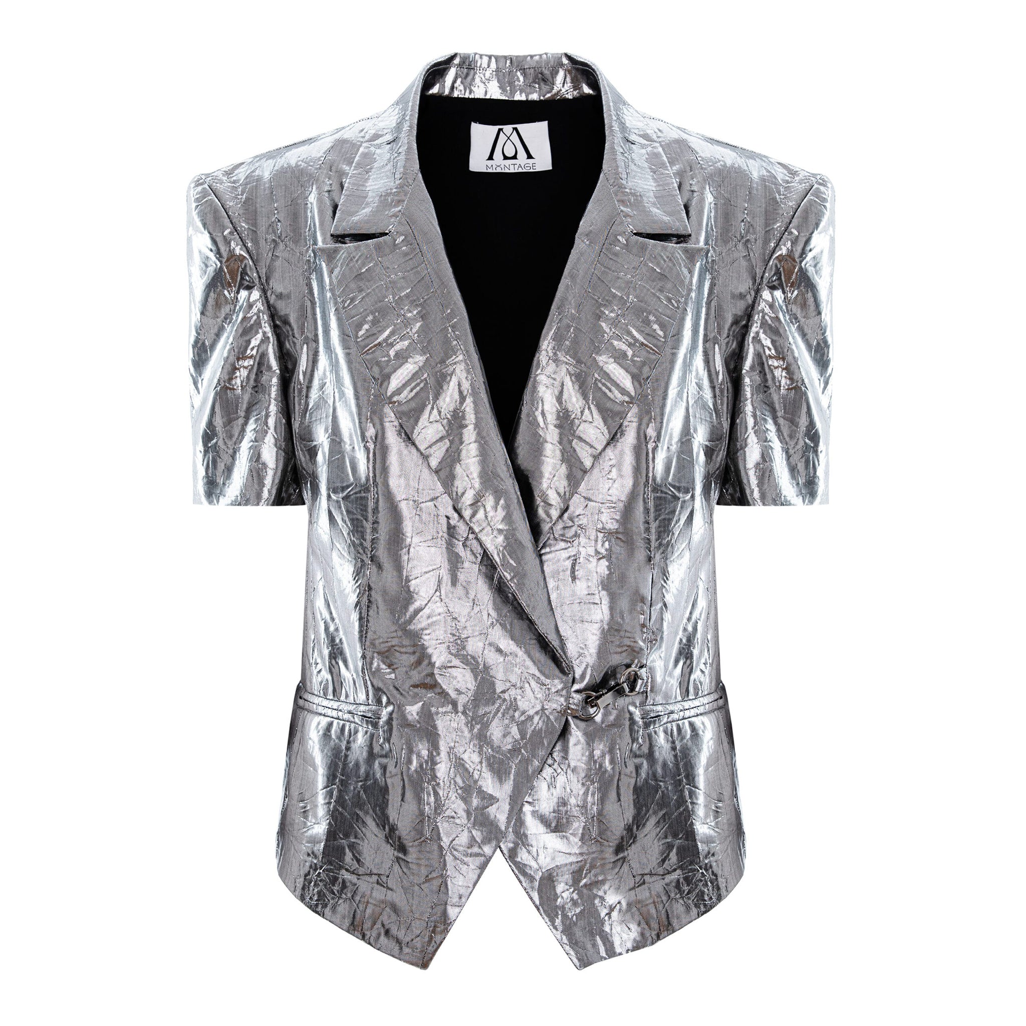 A metallic silver short-sleeve blazer with a crinkled, textured finish, featuring notch lapels, a wrap-style front, and a black inner lining, shown against a plain white background.